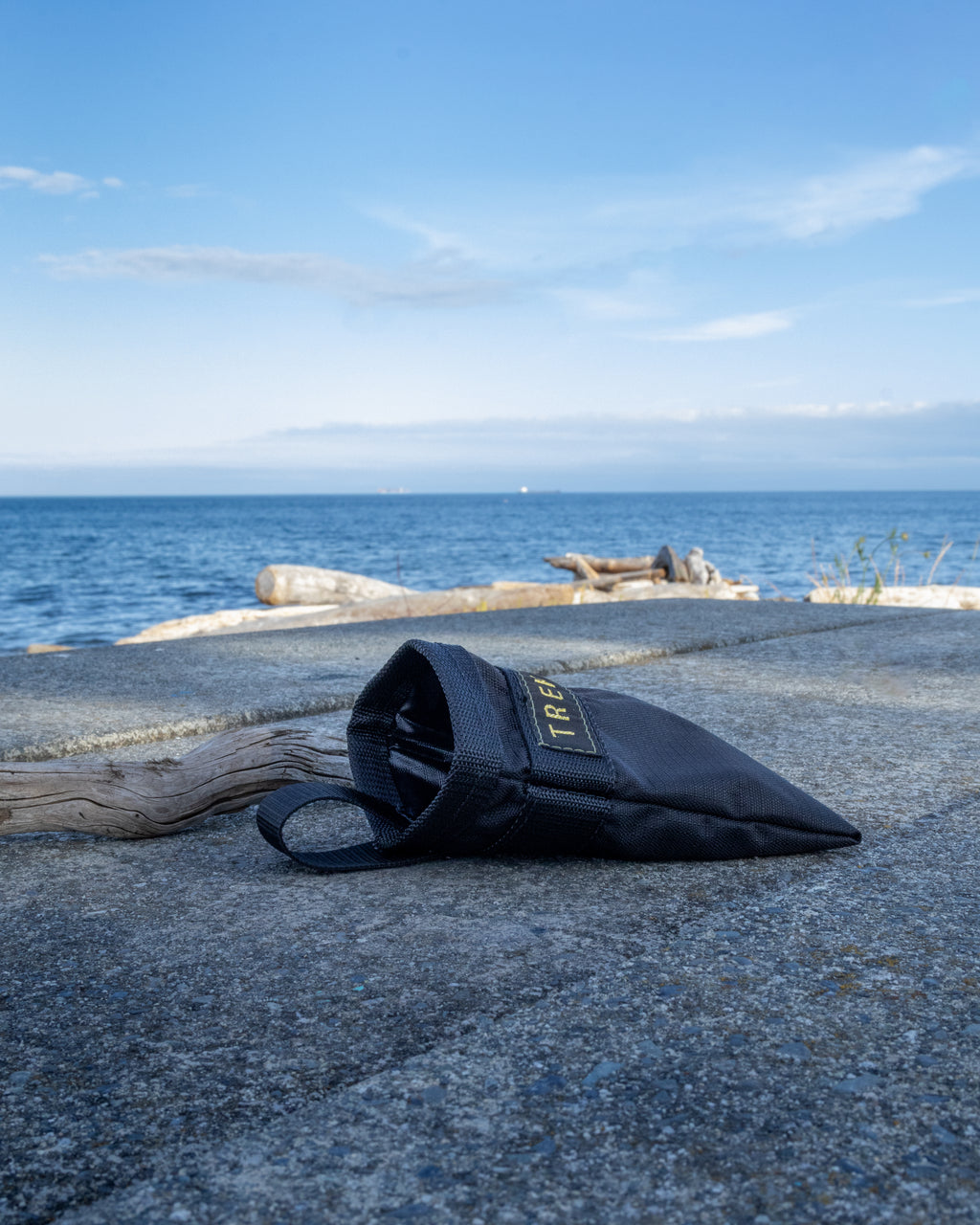 Black Trek-9 dog treat pouch with reversible liner and magnetic closure. Made from high durability ripstop fabric for both the shell and the liner. Easy to wash, and dries quick. Has a belt loop for attaching to body or bag. 